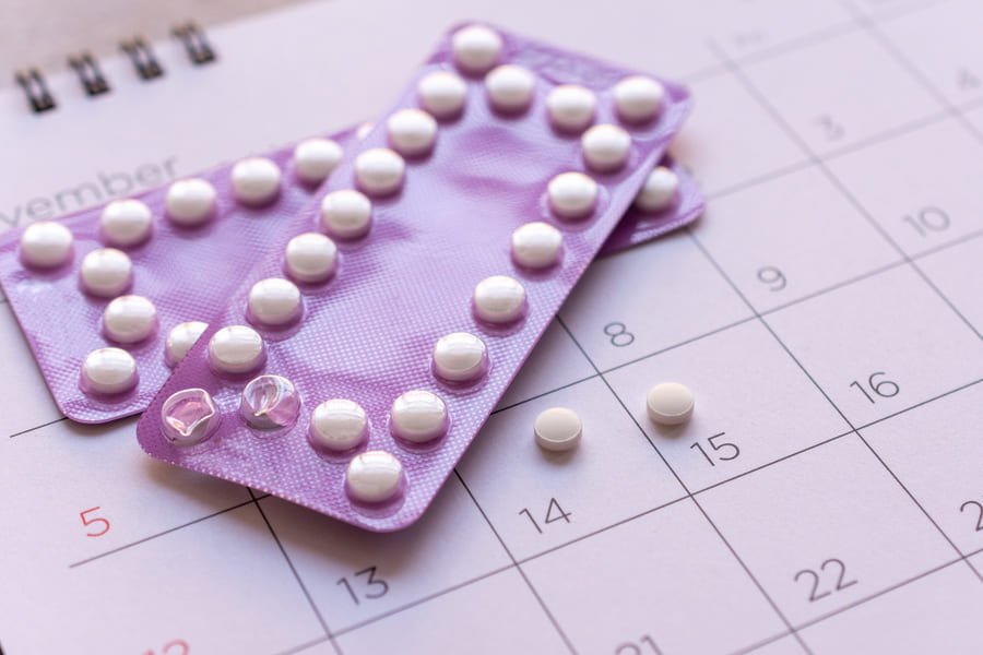 birth-control-pill-with-date-calendar-background-health-care-medicine-concept (1).jpeg