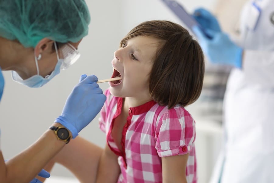 little-girl-s-throat-is-examined-doctor-s-appointment (1).jpeg