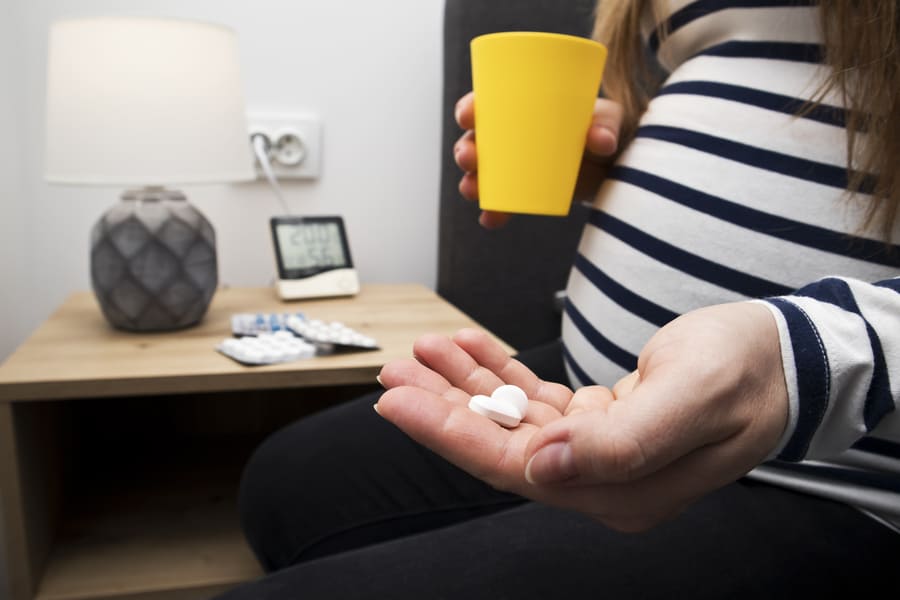 pills-pregnant-woman-s-hand-sitting-bed (1).jpeg