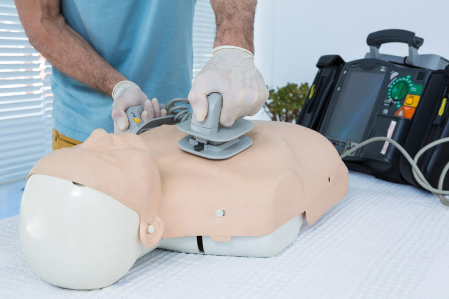 paramedic-practicing-resuscitation-dummy (1).jpeg